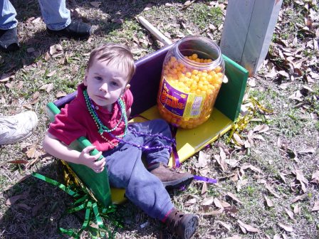 Josh with cheese balls in the parade ladder seat 